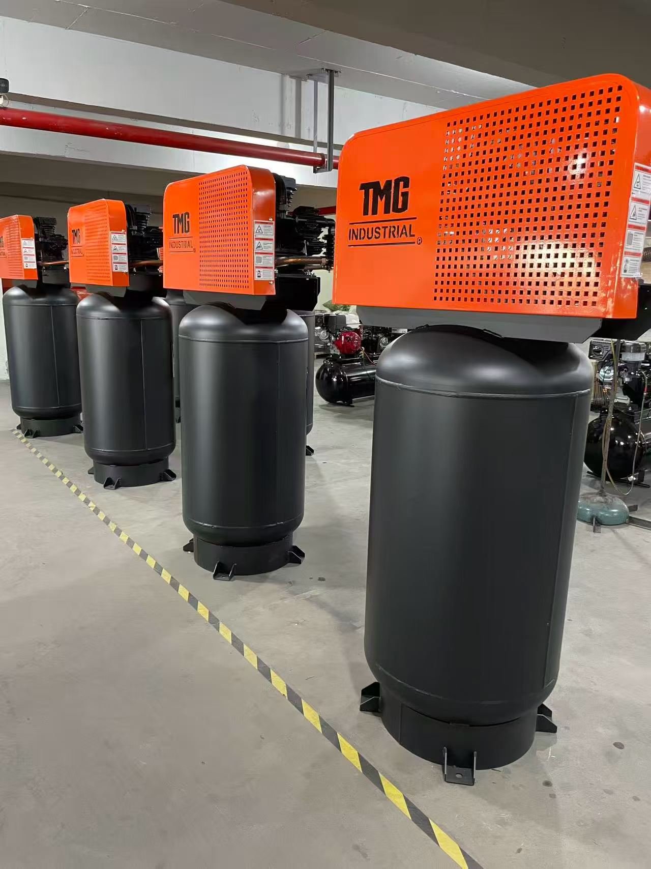 SAYI industrial centrifugal fans in orange finish lined up in the factory after final inspection