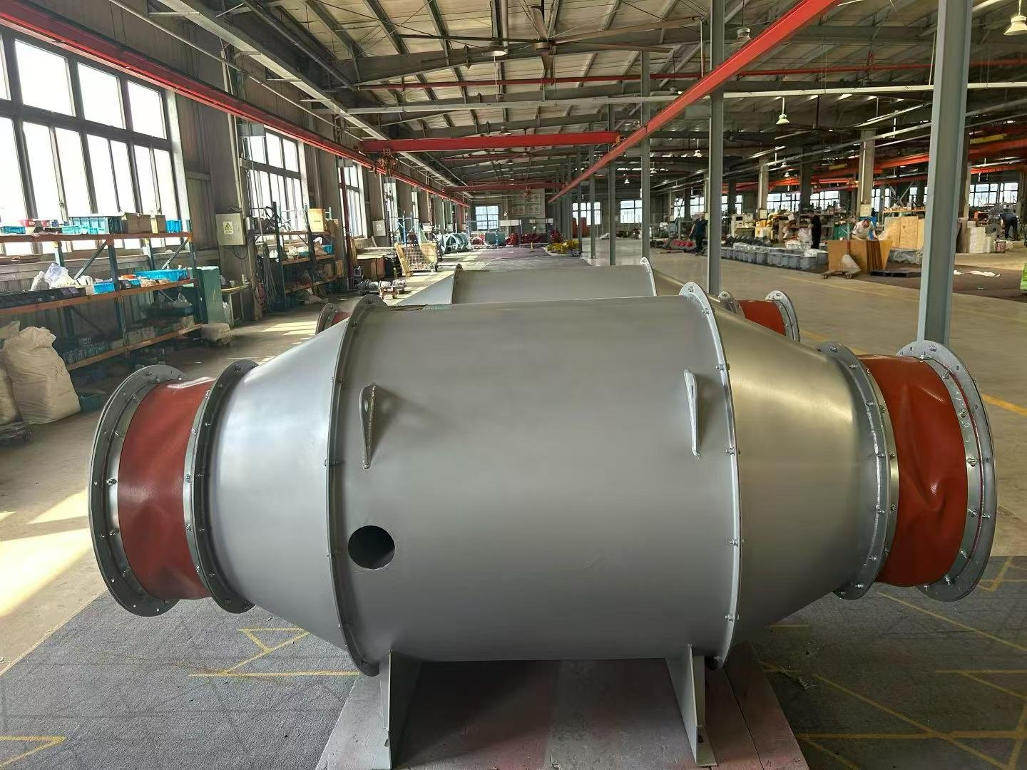 Blue centrifugal fans with motors assembled on pallets in the SAYI workshop